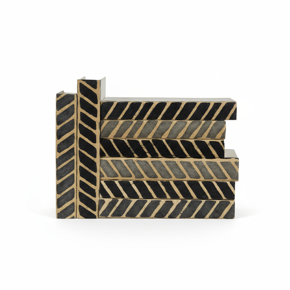 Set of decorative steps with black and gold chevron pattern on a white background