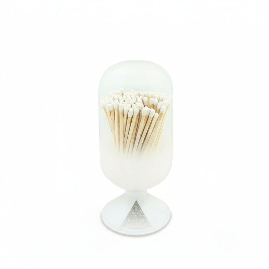 White cylindrical container with a lid filled with matches on a white background