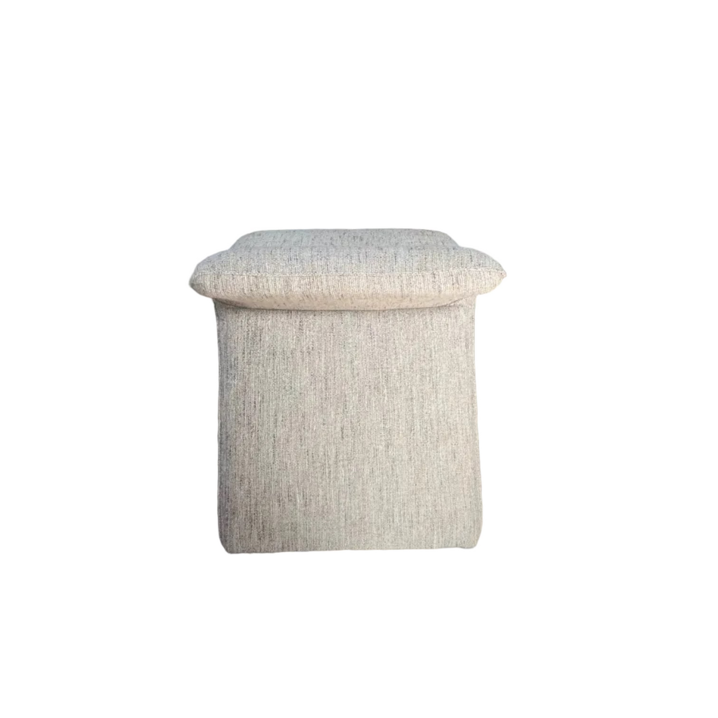 Textured ottoman on a wooden floor with a kitchen in the background
