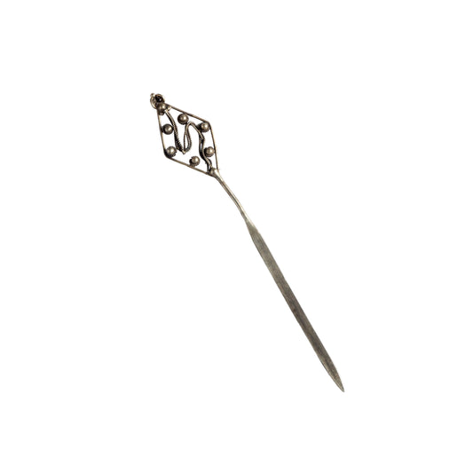 Silver hairpin with decorative top on a white background