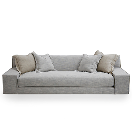 A gray Esme Sofa with knife edge toss pillows on a white background.